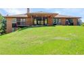 Expansive backyard features a covered patio, perfect for outdoor entertaining and relaxation at 6155 Meadowbrook Dr, Morrison, CO 80465