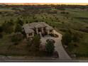 Beautiful exterior of a custom home nestled on a sprawling lot, showcasing the home's unique design at 6371 Diamond Ridge Pkwy, Castle Rock, CO 80108