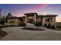 Charming home showcasing its front exterior, landscaped circle drive, and basketball court at 6371 Diamond Ridge Pkwy, Castle Rock, CO 80108