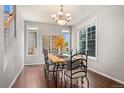 Well-lit dining room featuring a decorative chandelier and large windows at 10550 Sedalia St, Commerce City, CO 80022