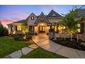 Inviting front entrance with double doors, stone accents, lush landscaping, and a curved walkway leading to the home at 4541 Tierra Alta Dr, Castle Rock, CO 80104