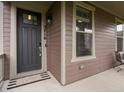 Inviting front entrance with a modern door, stylish hardware, and a welcoming mat at 5716 Boston Ct, Denver, CO 80238