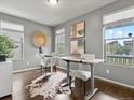 Bright home office featuring two workstations, hardwood floors, and ample natural light at 5716 Boston Ct, Denver, CO 80238