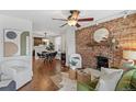 Stylish living room showcasing exposed brick fireplace, hardwood floors, and modern decor at 204 S Logan St, Denver, CO 80209