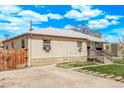 Single-story home featuring a long driveway and lush lawn at 2281 Oak Pl, Thornton, CO 80229