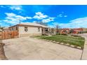 Single-story home featuring a concrete driveway and a well-maintained lawn at 2281 Oak Pl, Thornton, CO 80229