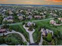 Expansive aerial view of a luxury neighborhood with sprawling green lawns and elegant homes at 485 Sapphire Dr, Castle Rock, CO 80108