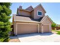 Spacious three-car garage offering ample parking and storage, complemented by the home's exterior design at 9688 Chesapeake St, Highlands Ranch, CO 80126