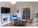 Cozy living room with hardwood floors, fireplace and french doors at 2614 Curtis St, Denver, CO 80205