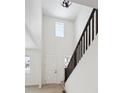 Bright entryway with high ceilings, hardwood floors, and a modern staircase at 692 Apex Rise St, Erie, CO 80516