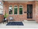 Cozy front porch with brick facade, seating, and stylish decor by the front door at 538 Cook St, Denver, CO 80206
