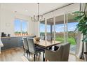 Bright dining area featuring a large window and sliding glass door leading to the outside, with views of the backyard at 21 N Edge Cliff St, Castle Rock, CO 80104