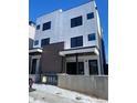 Contemporary duplex boasts a sleek white facade and dark brick base at 1252 Yates St, Denver, CO 80204