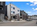 Modern townhomes with sleek designs, black-framed windows, and well-maintained landscaping on a sunny day at 1252 Yates St, Denver, CO 80204