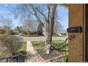 Close-up of the front porch showcases brick detailing and a metal railing at 2562 S Xavier St, Denver, CO 80219