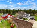 Expansive aerial view showing the home, surrounding acreage, and a large red barn at 37625 Pheasant Run, Elizabeth, CO 80107