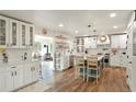 Beautiful kitchen featuring a center island, wood floors, and open dining area at 37625 Pheasant Run, Elizabeth, CO 80107