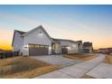 Street view of charming single-Gathering homes featuring 2-car garages and driveways at 7392 Timberstone St, Castle Pines, CO 80108