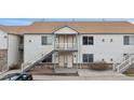Two-story condo building featuring private entrances and staircases on both sides at 18080 Becket Dr, Parker, CO 80134