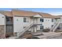 Two-story condo building with individual entrances and staircases at 18080 Becket Dr, Parker, CO 80134