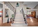 Inviting foyer featuring a staircase with wood and metal banisters, leading to the upper level at 2042 Chesapeake Pl, Highlands Ranch, CO 80126