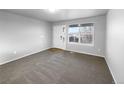 Bright and airy living room with neutral carpeting at 5242 Longs Peak St, Brighton, CO 80601