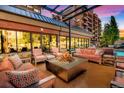 Cozy outdoor lounge area with a fireplace and comfortable seating for relaxing evenings at 405 Village Rd # 101, Breckenridge, CO 80424