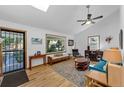 Bright living room with hardwood floors, vaulted ceilings, and a large window offering scenic views at 331 Sherman St, Longmont, CO 80501