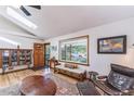 Cozy living room featuring a skylight, hardwood floors, and comfortable seating arrangements at 331 Sherman St, Longmont, CO 80501
