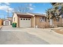 Charming single-story brick home with a well-maintained front yard and a long driveway leading to the attached one-car garage at 8481 Dawson Dr, Denver, CO 80229