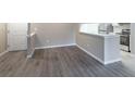 Bright living area with modern flooring, a convenient kitchen pass-through, and a welcoming front door at 7790 W 87Th Drive Dr # D, Arvada, CO 80005