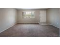 Neutral living room featuring carpet and a window at 9320 W 48Th Ave, Wheat Ridge, CO 80033