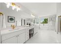 Elegant bathroom featuring double vanities, a soaking tub, and modern fixtures at 9117 Buck Hill Dr, Highlands Ranch, CO 80126