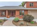 Charming home featuring an inviting covered front porch and meticulously landscaped front yard at 5420 Crestone Cir, Boulder, CO 80301