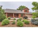 Inviting home featuring an inviting covered front porch and meticulously landscaped front yard at 5420 Crestone Cir, Boulder, CO 80301