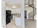 Modern kitchen featuring white cabinetry, stainless steel appliances, and granite countertops at 8361 S Upham Way # 209, Littleton, CO 80128