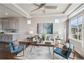 Bright living room with modern decor, plush seating, and a decorative ceiling fan at 8095 E 128Th Pl, Thornton, CO 80602