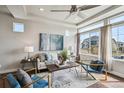 Bright and airy living room with large windows, stylish decor, and a comfortable seating area, perfect for relaxation and entertainment at 8095 E 128Th Pl, Thornton, CO 80602
