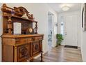 Bright entryway with antique wooden cabinet and hardwood floors at 8115 Monte Vista Cir, Littleton, CO 80125