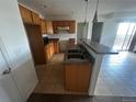 A view of the kitchen and wet bar, featuring wooden cabinets, and tile flooring at 2005 W 86Th Ave, Denver, CO 80260