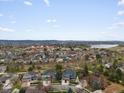 Expansive aerial view of a community near the mountains featuring homes, streets, and a view of the lake at 5497 W Prentice Ct, Littleton, CO 80123