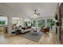 Bright living room with fireplace, large windows, and neutral decor at 2840 Canyon Crest Ln, Highlands Ranch, CO 80126