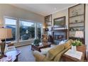 Spacious living room with a fireplace, built-in shelving, and mountain views at 334 Humphrey Dr, Evergreen, CO 80439