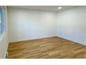 Empty living room with light wood floors and white walls at 14023 E Utah Cir, Aurora, CO 80012