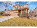 Inviting two-story home with a front yard, driveway, and a charming covered porch at 15112 E 116Th Pl, Commerce City, CO 80603