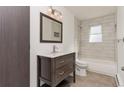 Updated bathroom featuring vanity with a marble countertop, and a tub with white subway tile surround at 5700 W 28Th Ave # 6, Wheat Ridge, CO 80214