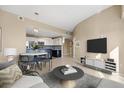 Comfortable living area with a view into the modern kitchen, featuring sleek countertops at 15475 Andrews Dr # 314, Denver, CO 80239