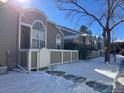 Exterior view of townhome with snowy landscaping at 5866 W Asbury Pl, Lakewood, CO 80227