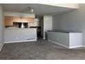 Open-concept living area with view of the kitchen and modern appliances at 5866 W Asbury Pl, Lakewood, CO 80227