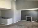 Spacious living room featuring high ceilings and a cozy fireplace at 5866 W Asbury Pl, Lakewood, CO 80227